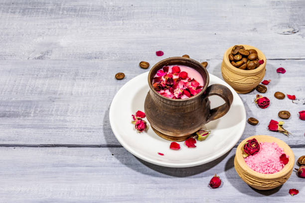 trendy colored latte. rose petals and powdered aromatic sugar, coffee beans. wooden boards background - coffee cup bean sugar imagens e fotografias de stock