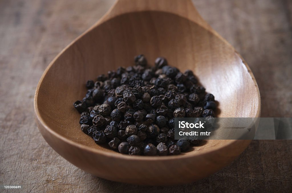 Black pepper  on wooden spoon Black pepper on wooden spoon Black Peppercorn Stock Photo