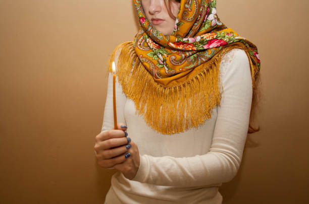 istock Russian orthodox girl is praying with candle 1203007666