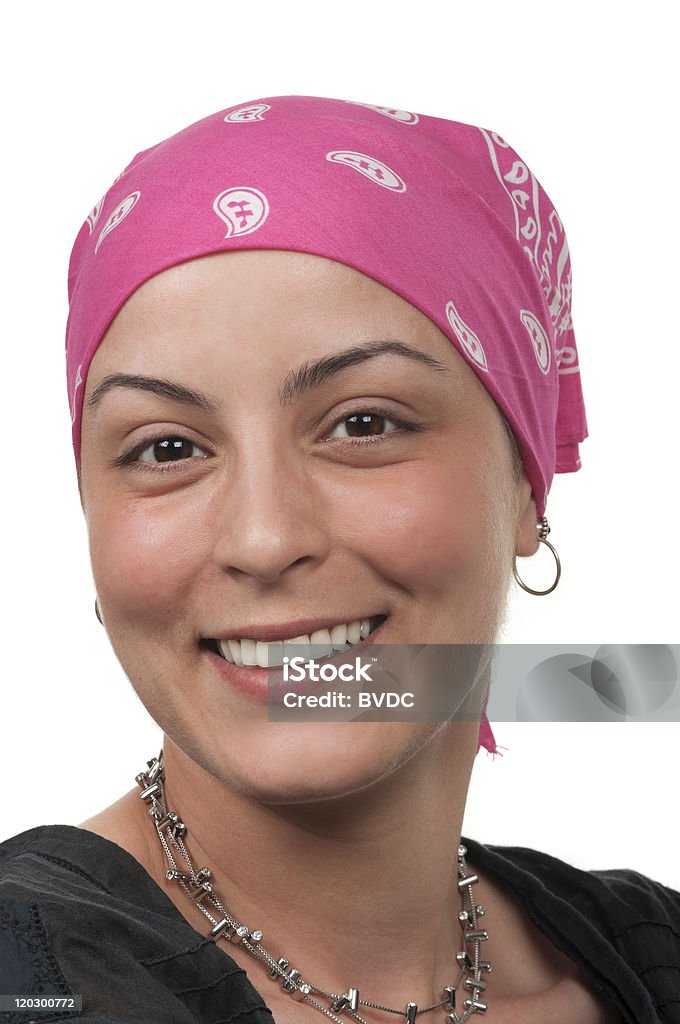 A smiling female cancer survivor wearing a pink bandanna Breast cancer survivor Cancer - Illness Stock Photo