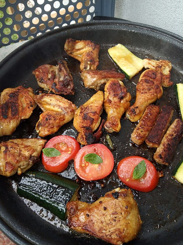 grilled meat with tomatoes and vegetables at summer