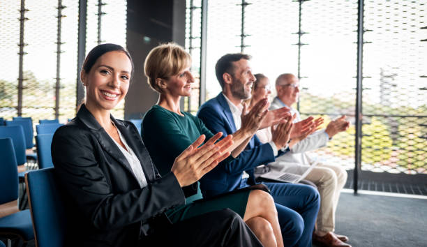 istock Happy audience applauding speaker at business conference 1203007916