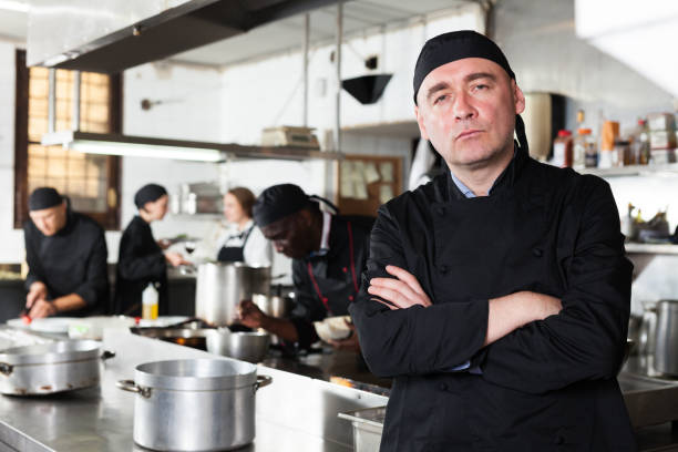 istock Professional male chef in kitchen of restaurant 1203008122