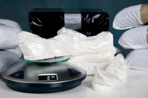 Photo of Illegal drugs on a scale measuring five ounces