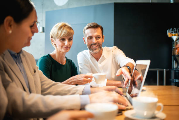 istock Business people talking about project in a cafe 1203009508