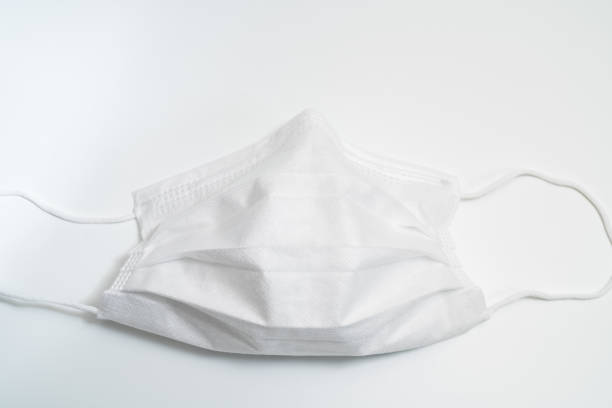 istock Protective medical mask on white background. 1203011428