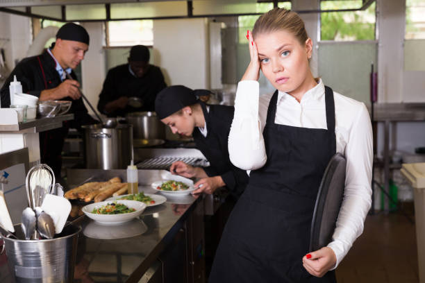 istock Upset waitress in kitchen of restaurant 1203011572