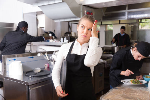 istock Upset waitress in kitchen of restaurant 1203011609