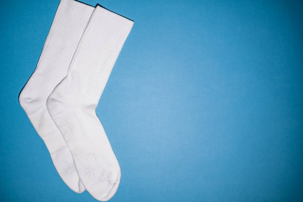 A pair of white tube socks on a blue background.