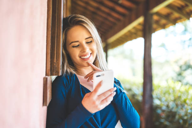 istock Young woman distracted on cellphone 1203014210