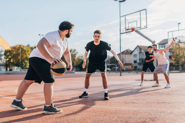 istock Men friends playing basketball 1203015153