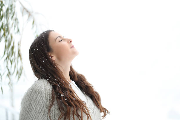 istock Relaxed girl breathing fresh air under snow 1203015266