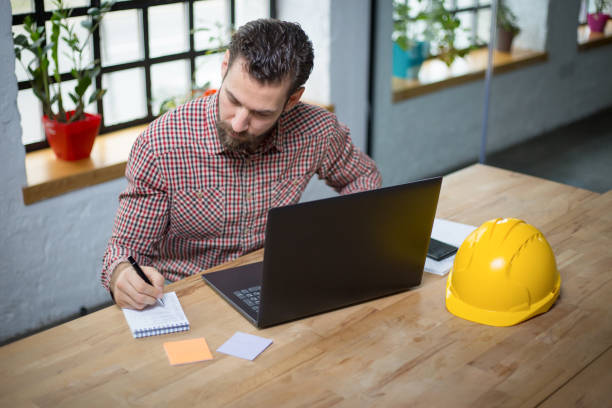istock Young architect working on new ideas at his office 1203015834