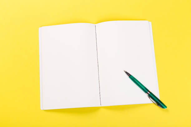 istock Sketchbook on colorful background. Copy space. top view of blank open notebook, concept of education or new workplace 1203017478