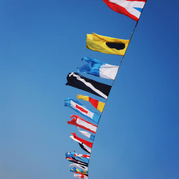 istock Beautiful blue sky with flags full of colour. 1203019103