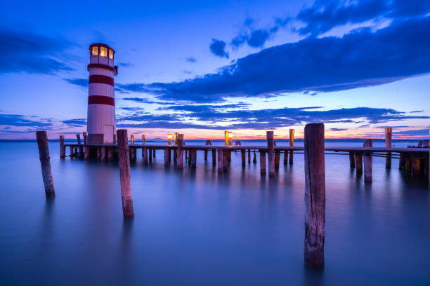 podersdorf neusiedlersee sunset in austria with lighthouse at twilight, lake and blurred water due to long exposure