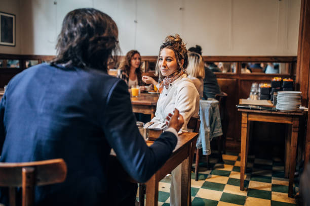 istock Couple sitting in coffee shop 1203020667