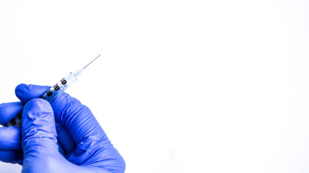 istock Banner Hand in blue glove holding insulin syringe isolated on white background, Copy space 1203024465