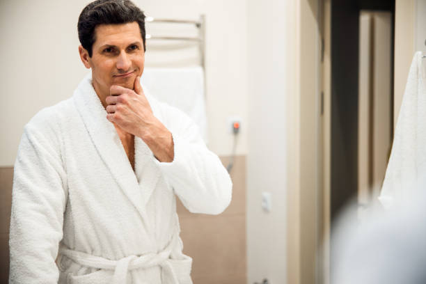 istock Smiling man posing in bathroom at home 1203027839