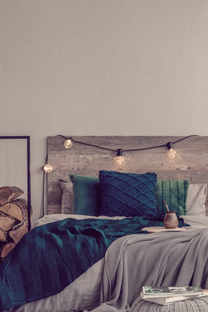 istock Vertical view of rustic bedroom design and copy space on empty grey wall 1203027964