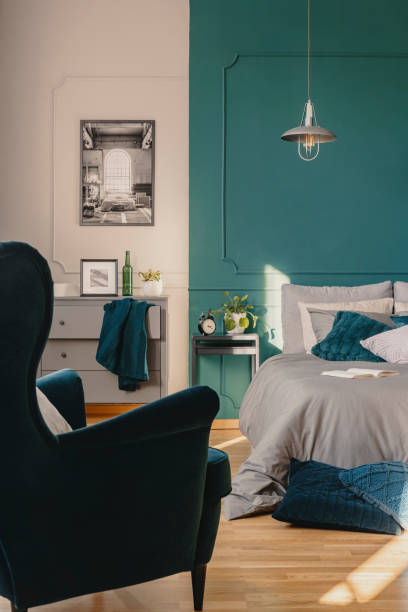 istock Copy space on empty green wall of elegant bedroom interior 1203028018