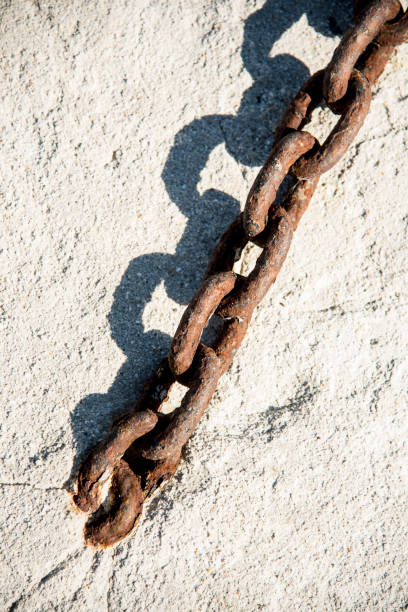 istock rusty chains in the harbor by the sea 1203028130