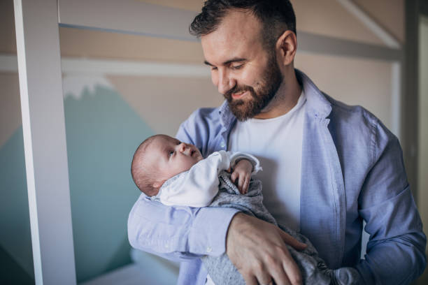istock Father holding baby son 1203032382