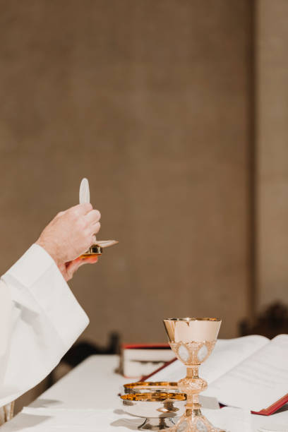 istock unrecognizable Priest holding the goblet during a wedding ceremony nuptial mass. Religion concept 1203032651