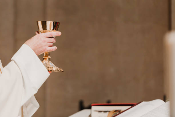 unrecognizable Priest holding the goblet during a wedding ceremony nuptial mass. Religion concept stock photo