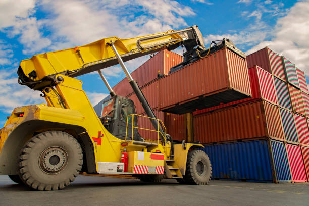 istock Crane lifting up container in a port. 1203032911