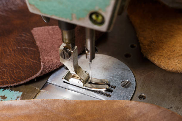 istock Old sewing machine and natural cow leathers. Selective focus. 1203034380