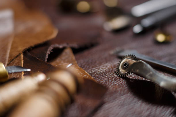 istock Pieces of natural cow leather and working tools in the tailoring workshop. 1203034405
