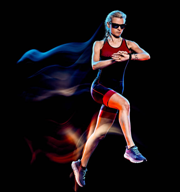 istock woman triathlon triathlete runner running joogger jogging  isolated black background 1203035573