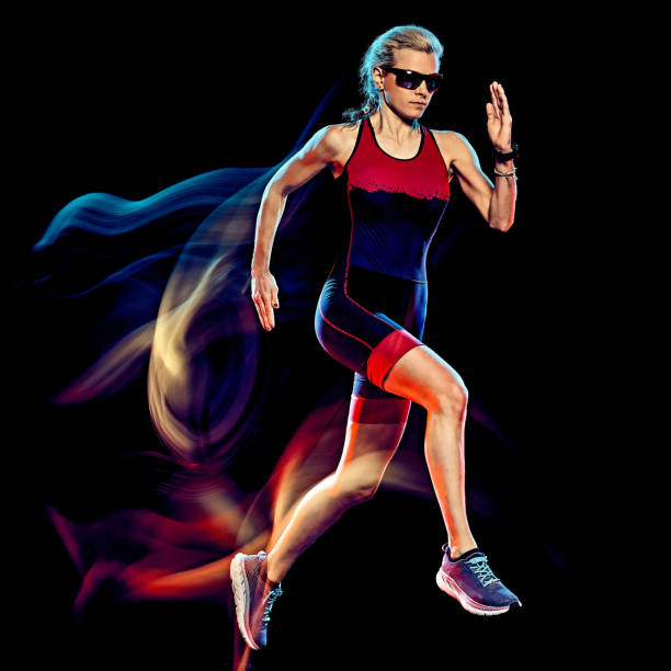 istock woman triathlon triathlete runner running joogger jogging  isolated black background 1203035648