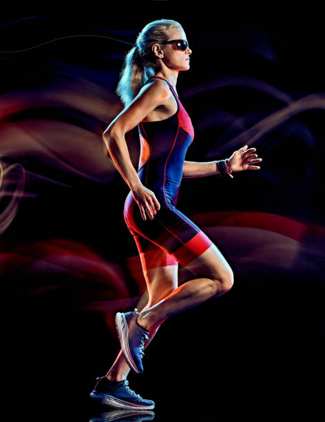 istock woman triathlon triathlete runner running joogger jogging  isolated black background 1203035661