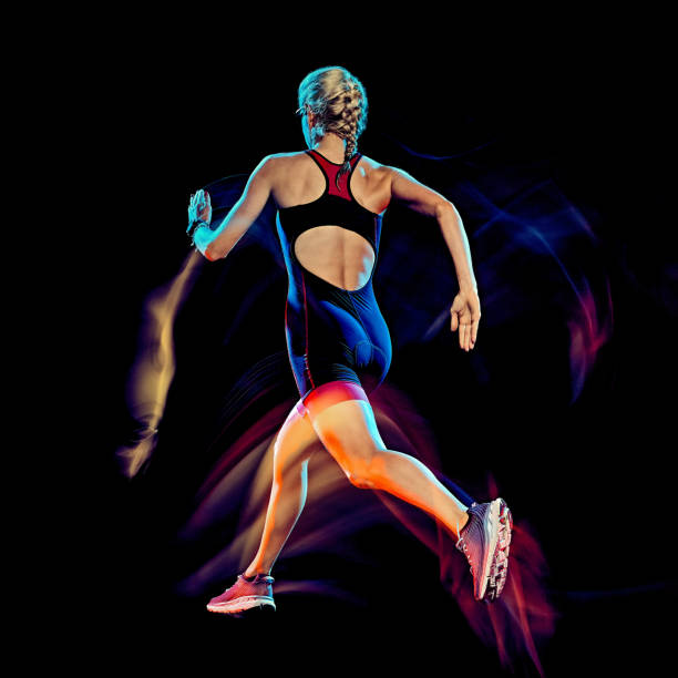 istock woman triathlon triathlete runner running joogger jogging  isolated black background 1203035678