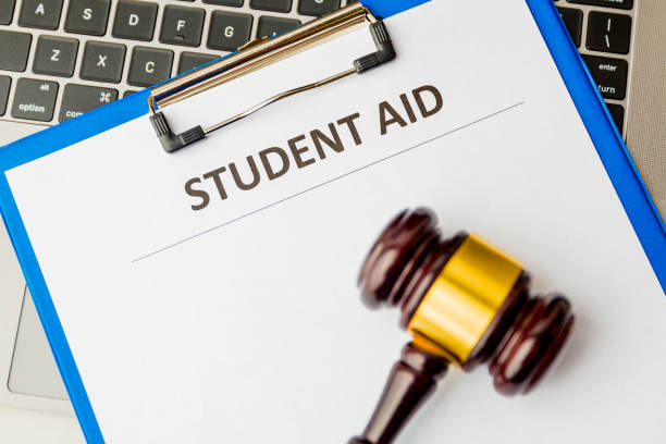 istock Document with student aid and wooden gavel on the table with laptop isolated. 1203036080