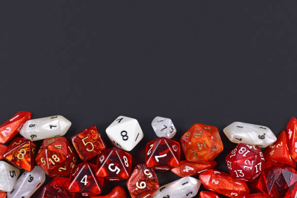 istock Background with different roleplaying RPG dice at bottom of dark black background with blank copy space 1203038746