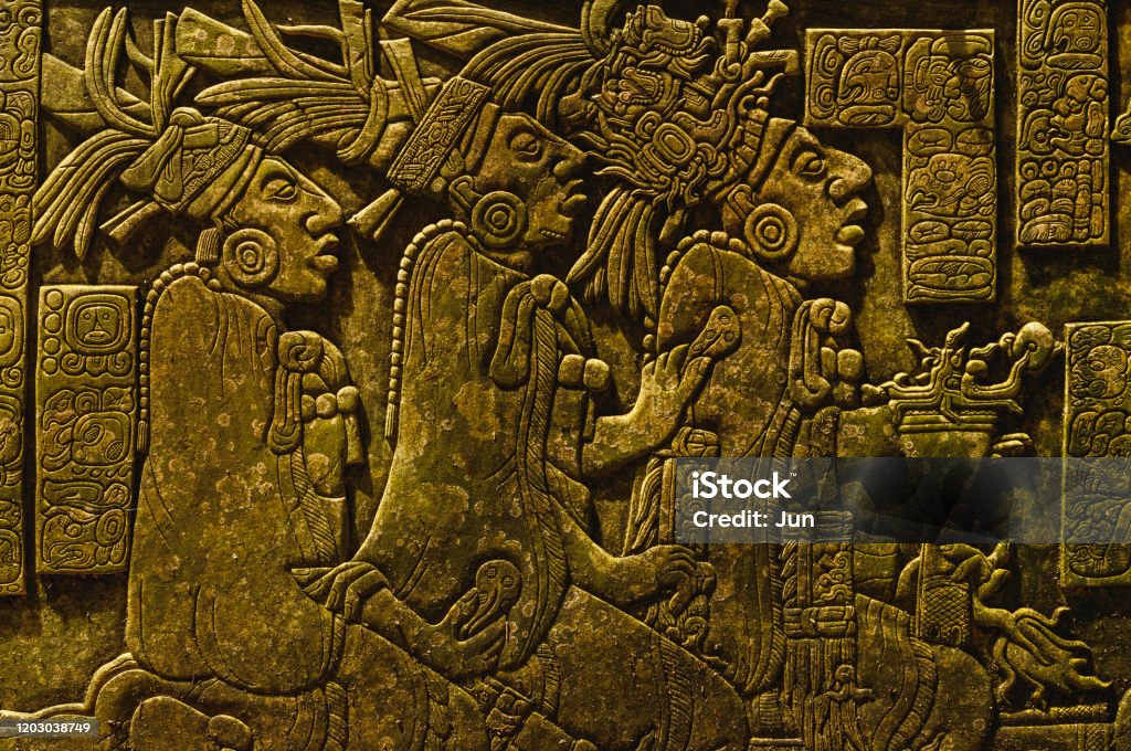 Ancient Mayan drawings on the stone wall Ancient Mayan drawings carved on the stone wall Mayan Stock Photo