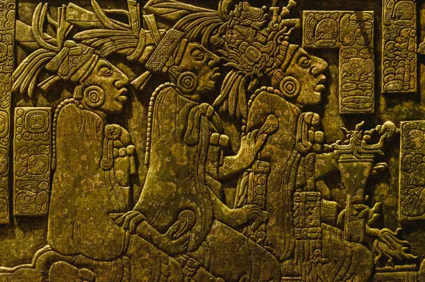 Photo of Ancient Mayan drawings on the stone wall