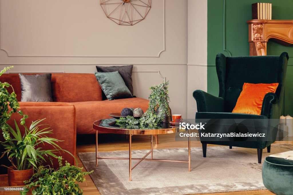 Urban jungle in beautiful living room with grey, orange and green interior Living Room Stock Photo