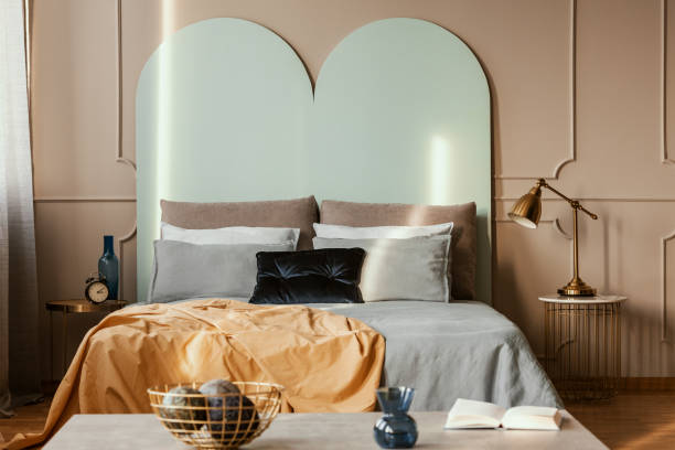 istock Knick knacks on console table in from of king size bed with comfortable bedding 1203040736