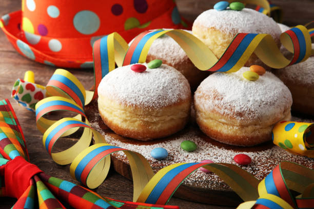 istock Carnival powdered sugar raised donuts with paper streamers. German berliner or krapfen for carnival 1203041717