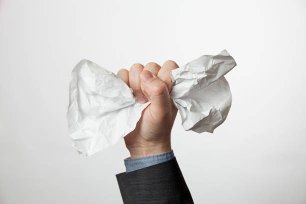 istock Crumpled A4 paper document in businessman hands. Office problems concept 1203041981