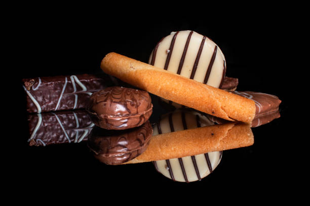 istock Sweet cookies and candies with reflection on shiny black background 1203042796