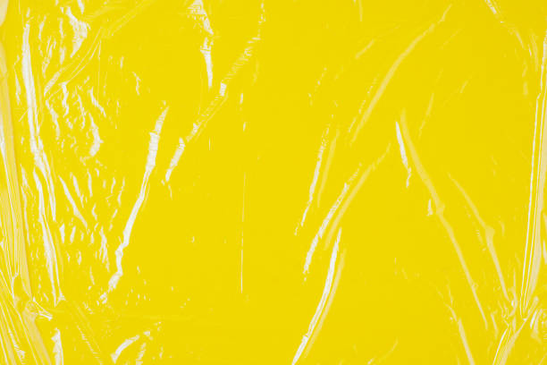istock Transparent cellophane texture on an yellow backing 1203043194