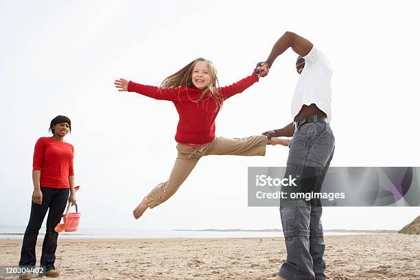 Young Family Having Fun On Beach Stock Photo - Download Image Now - 20-29 Years, 30-39 Years, 6-7 Years