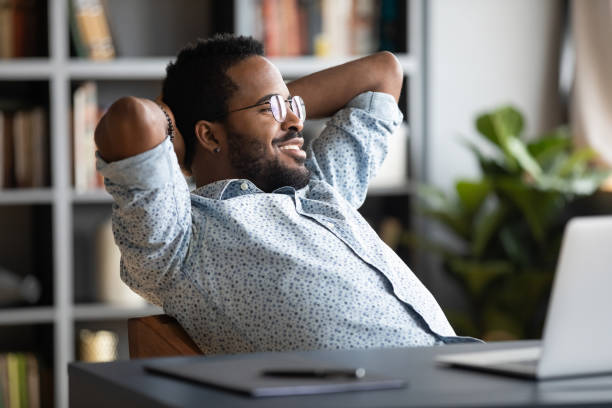 istock Relaxed calm african businessman resting sit at office desk 1203044193