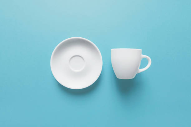 White cup and saucer isolated on light blue