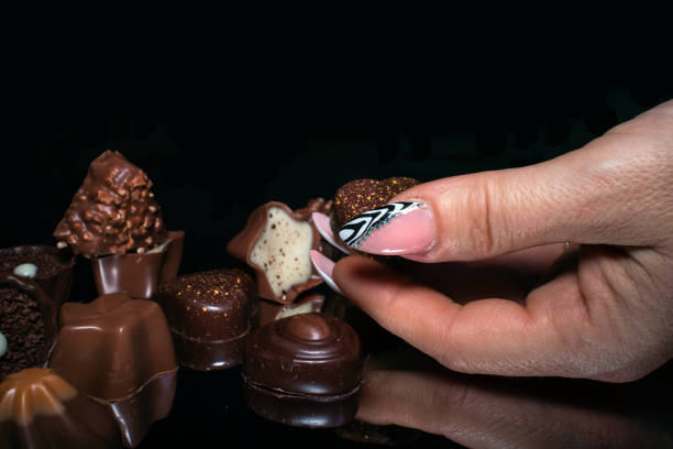istock Woman's hands with manicured nails holding sweet cookies 1203044667